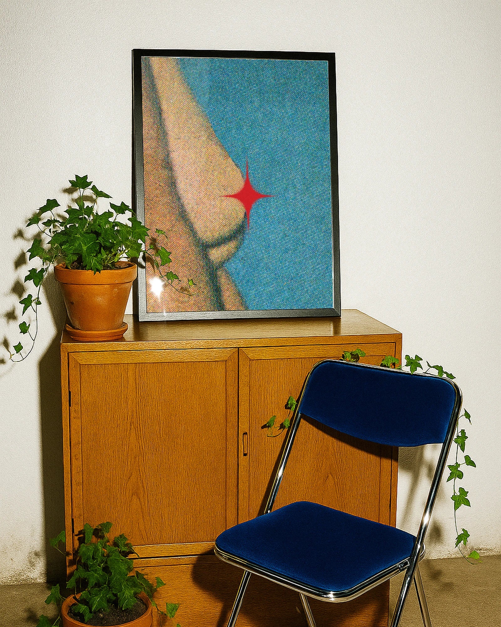 A framed poster showing female breasts coevered with a red star, abstract and grainy style.