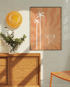 A print with an illustrated lesbian, baked couple dancing under a red sun and palms.