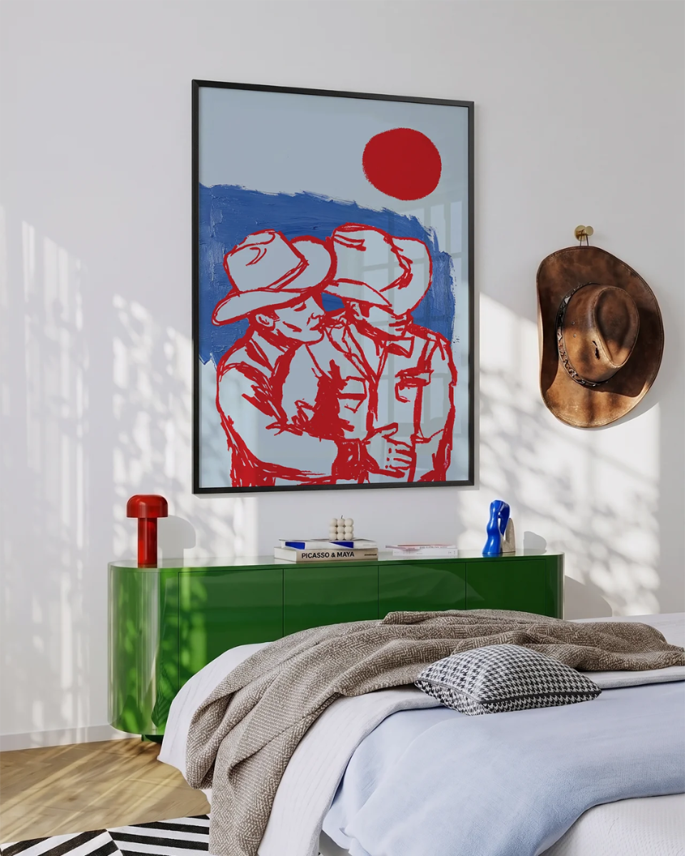 A poster with two ay cowboys hugging in front of a red sunset.