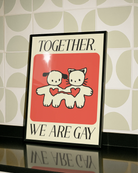 A poster with two cute figures holding hands, with the text 'Together, we are gay'.